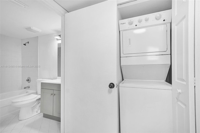 3398 NE 9th Dr Unit 104, Homestead, FL 33033 - laundry area featuring stacked washer / drying machine and light tile patterned flooring