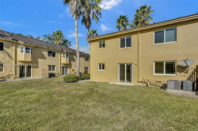 3398 NE 9th Dr Unit 104, Homestead, FL 33033 - back of house with stucco siding, central air condition unit, and a yard