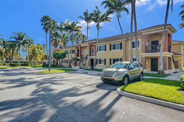 3398 NE 9th Dr Unit 104, Homestead, FL 33033 - view of building exterior with uncovered parking