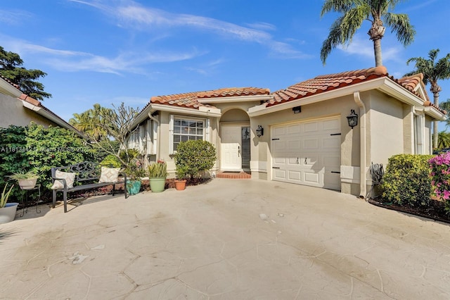 6081 Bluegrass Dr, Boynton Beach, FL 33437 - mediterranean / spanish-style home featuring a tiled roof, a garage, driveway, and stucco siding
