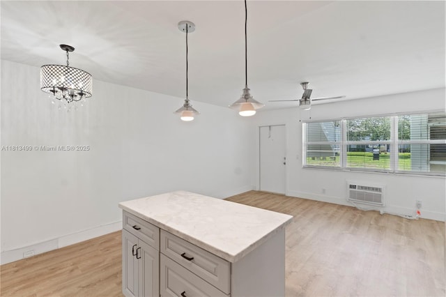 67 Harwood H Unit 67, Deerfield Beach, FL 33442 - kitchen with a wall mounted AC, light wood-style flooring, pendant lighting, and a chandelier