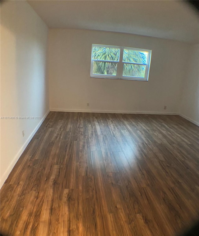 2061 NW 47th Ter Unit 205, Lauderhill, FL 33313 - empty room with dark wood finished floors and baseboards