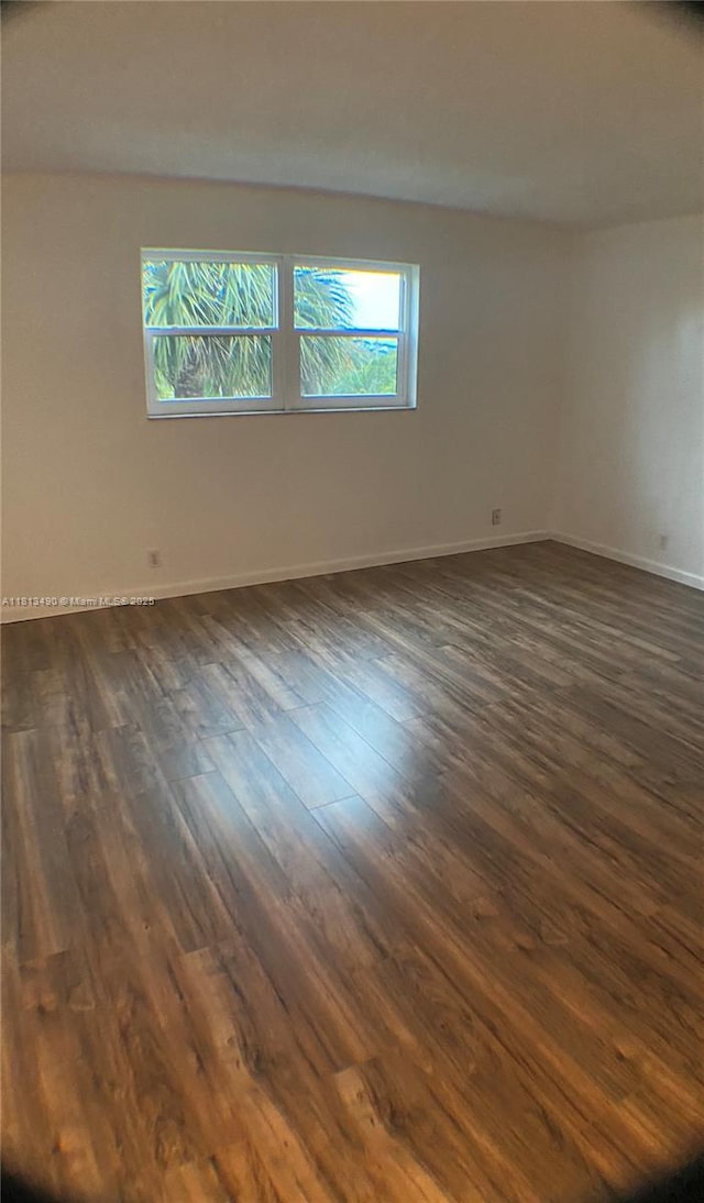 2061 NW 47th Ter Unit 205, Lauderhill, FL 33313 - spare room featuring dark wood-type flooring and baseboards