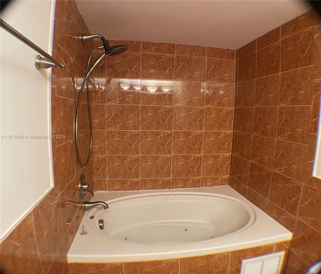 2061 NW 47th Ter Unit 205, Lauderhill, FL 33313 - bathroom with a combined bath / shower with jetted tub and tile walls