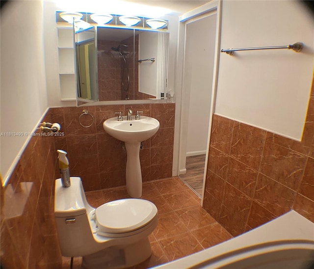 2061 NW 47th Ter Unit 205, Lauderhill, FL 33313 - bathroom with tile walls, wainscoting, toilet, and a shower
