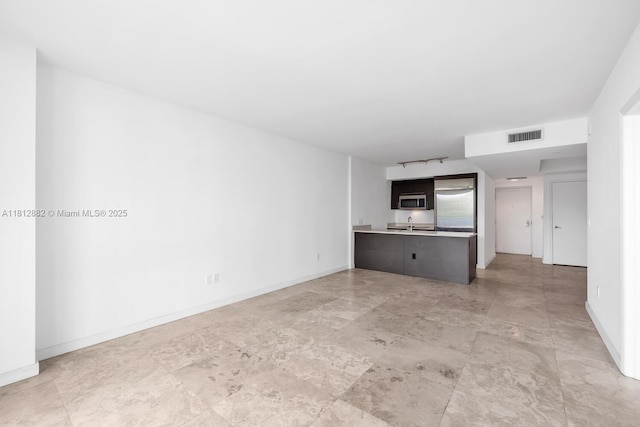 500 Brickell Ave Unit 400, Miami, FL 33131 - unfurnished living room featuring baseboards and a sink