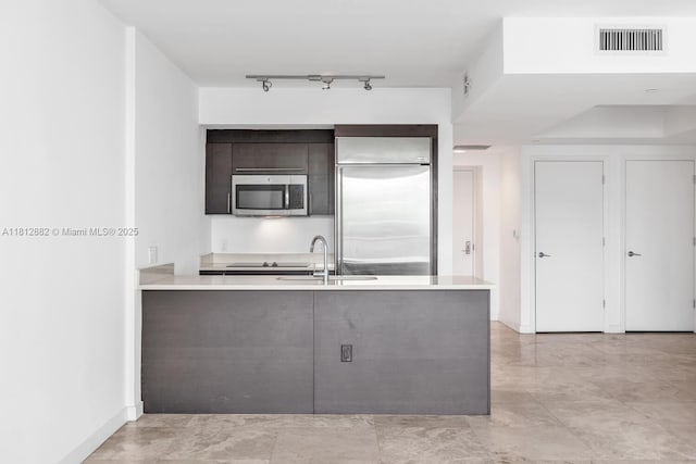 500 Brickell Ave Unit 400, Miami, FL 33131 - kitchen featuring stainless steel appliances, a sink, modern cabinets, light countertops, and a peninsula