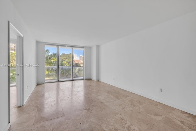 500 Brickell Ave Unit 400, Miami, FL 33131 - spare room featuring expansive windows and baseboards