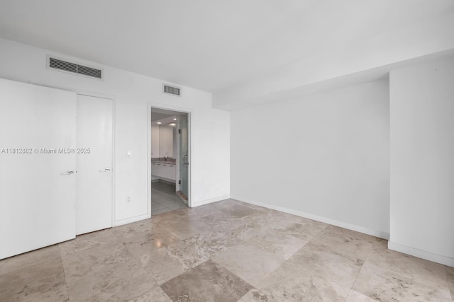 500 Brickell Ave Unit 400, Miami, FL 33131 - unfurnished bedroom with baseboards and ensuite bathroom