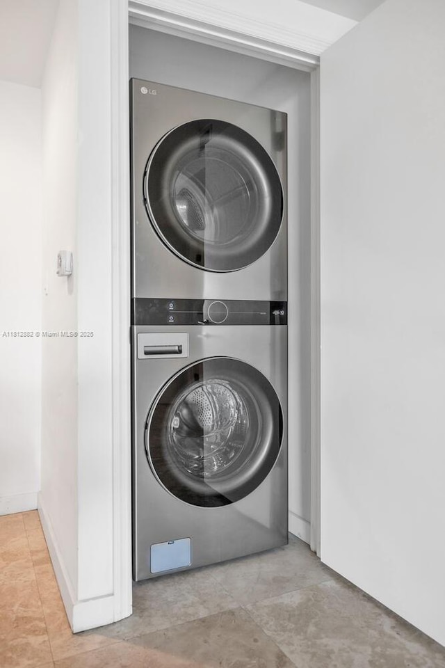 500 Brickell Ave Unit 400, Miami, FL 33131 - washroom featuring stacked washer / dryer and tile patterned flooring