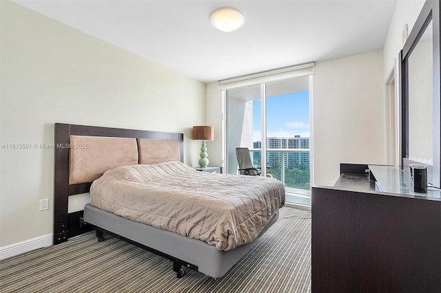19400 Turnberry Way Unit 1131, Aventura, FL 33180 - bedroom with access to outside, a wall of windows, baseboards, and carpet