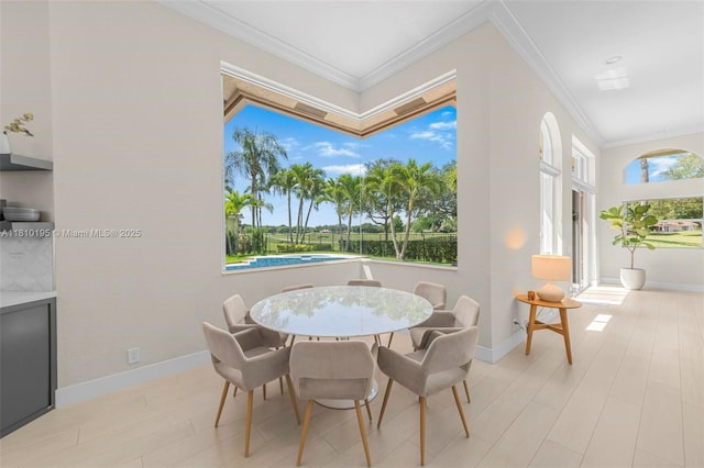 2539 Eagle Run Dr, Weston, FL 33327 - dining space with ornamental molding, baseboards, and light wood-type flooring