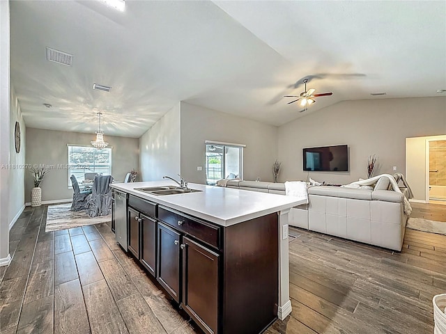 6142 NW Hopkins Ave, Port St Lucie, FL 34986 - kitchen featuring a sink, hardwood / wood-style flooring, stainless steel dishwasher, light countertops, and open floor plan
