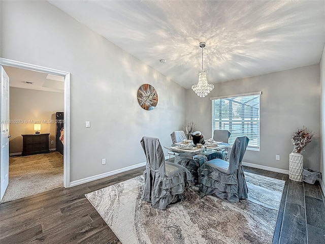 6142 NW Hopkins Ave, Port St Lucie, FL 34986 - dining room with a chandelier, wood finished floors, and baseboards