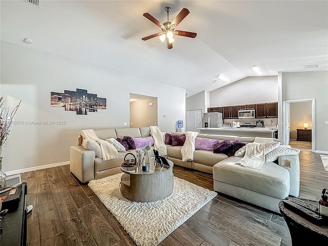 6142 NW Hopkins Ave, Port St Lucie, FL 34986 - living room with vaulted ceiling, ceiling fan, dark wood-style flooring, and baseboards