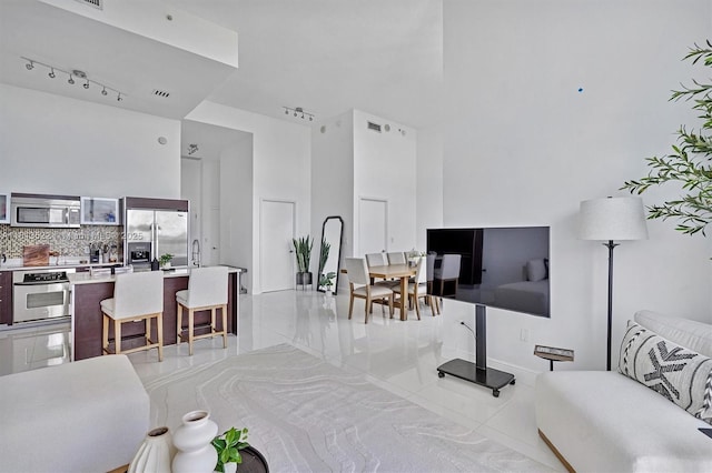 1900 N Bayshore Dr Unit 603, Miami, FL 33132 - living area featuring light tile patterned flooring and a high ceiling
