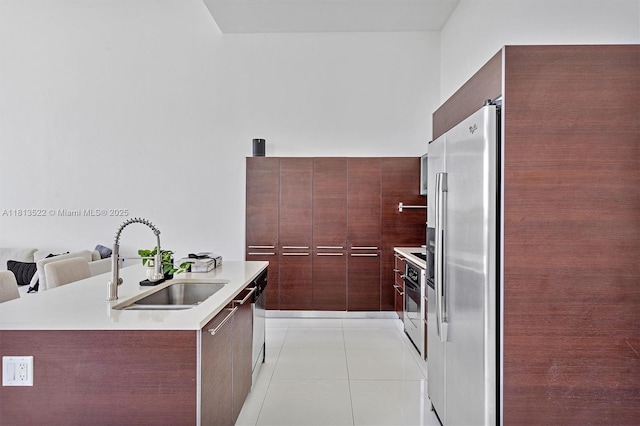 1900 N Bayshore Dr Unit 603, Miami, FL 33132 - kitchen with stainless steel fridge, modern cabinets, light tile patterned floors, light countertops, and range