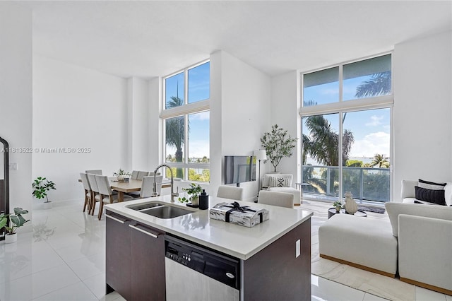 1900 N Bayshore Dr Unit 603, Miami, FL 33132 - kitchen with dishwasher, open floor plan, a kitchen island with sink, healthy amount of natural light, and a wall of windows