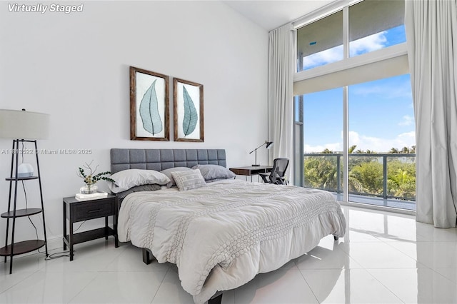 1900 N Bayshore Dr Unit 603, Miami, FL 33132 - bedroom with a high ceiling, light tile patterned floors, multiple windows, floor to ceiling windows, and access to outside