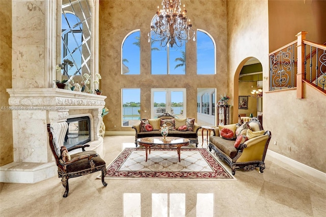 3308 Islewood Ave, Weston, FL 33332 - living area featuring a chandelier, a high ceiling, baseboards, arched walkways, and a water view