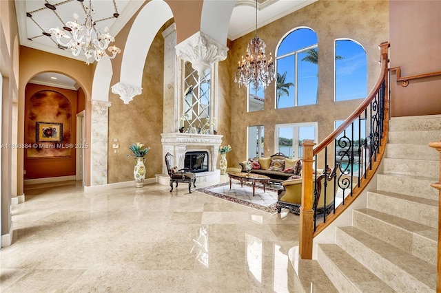 3308 Islewood Ave, Weston, FL 33332 - living room featuring a chandelier, arched walkways, crown molding, a towering ceiling, and baseboards