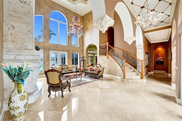 3308 Islewood Ave, Weston, FL 33332 - foyer with a towering ceiling, arched walkways, a chandelier, ornamental molding, and stairs