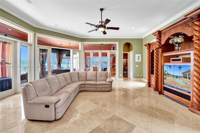 3308 Islewood Ave, Weston, FL 33332 - living room with crown molding, arched walkways, a ceiling fan, baseboards, and a textured ceiling