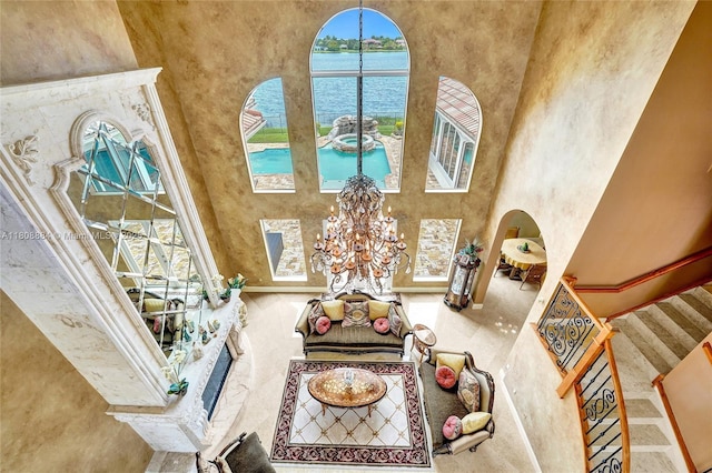 3308 Islewood Ave, Weston, FL 33332 - living room featuring a towering ceiling, a water view, a chandelier, and stairway