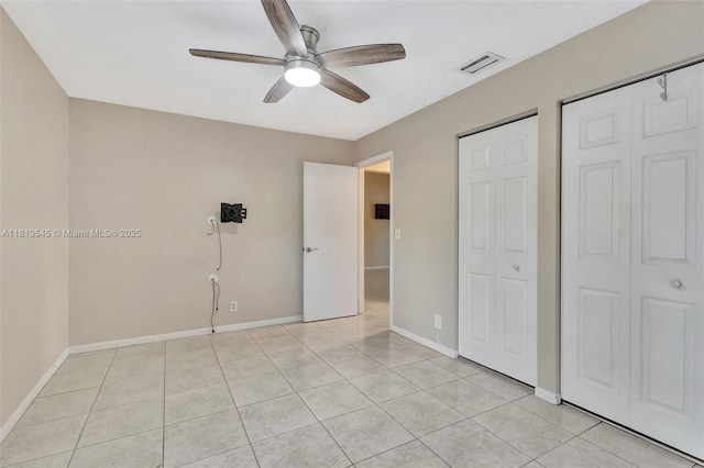4864 Sable Pine Cir Unit A, West Palm Beach, FL 33417 - unfurnished bedroom featuring baseboards, light tile patterned floors, and a ceiling fan