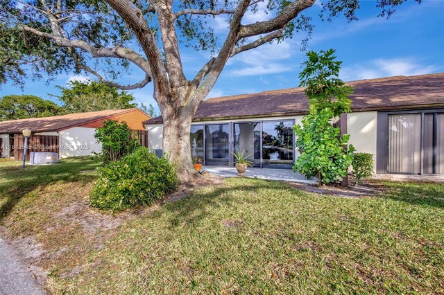 4864 Sable Pine Cir Unit A, West Palm Beach, FL 33417 - rear view of property with a yard and stucco siding