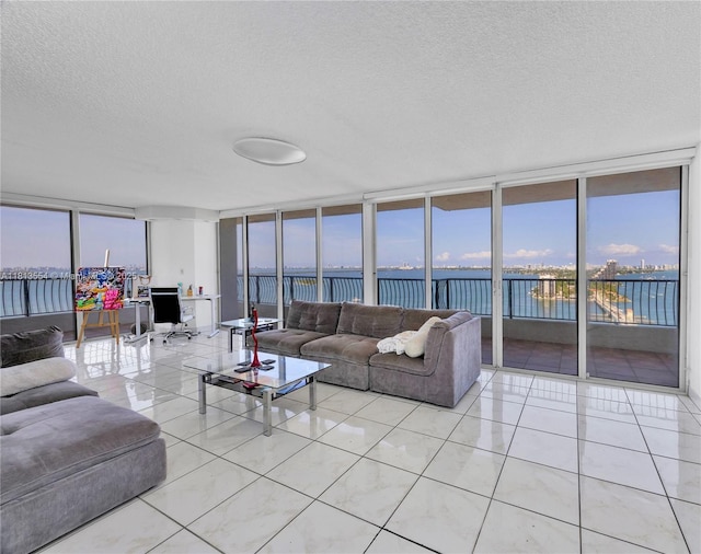 555 NE 15th St Unit 24C, Miami, FL 33132 - living area featuring a textured ceiling, a wall of windows, a water view, and light tile patterned flooring