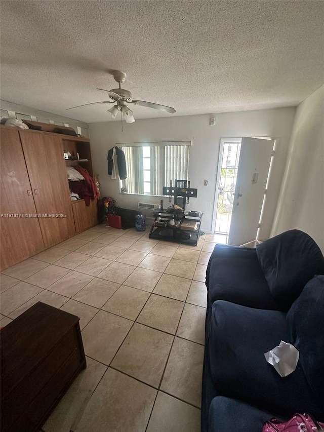 100 NW 204th St Unit 3, Miami Gardens, FL 33169 - living area featuring light tile patterned flooring, healthy amount of natural light, ceiling fan, and a textured ceiling