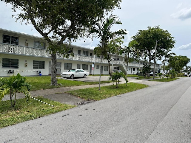 100 NW 204th St Unit 3, Miami Gardens, FL 33169 - view of front of house featuring uncovered parking and a front yard