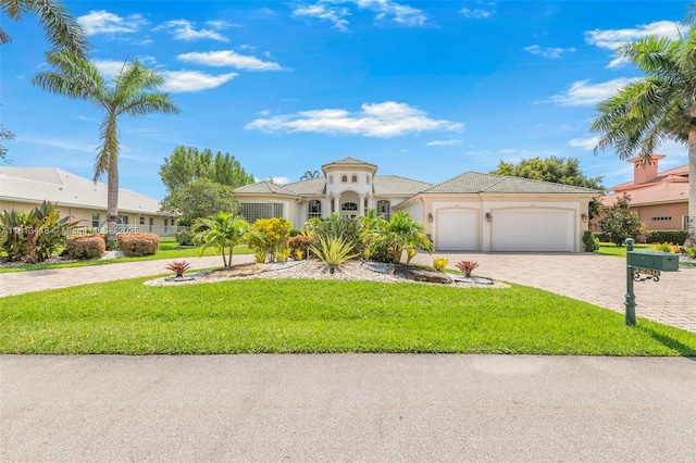 3250 W Stonebrook Cir, Davie, FL 33330 - mediterranean / spanish-style house with an attached garage, driveway, a front yard, and stucco siding