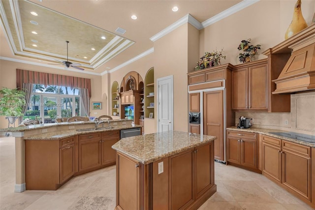 3250 W Stonebrook Cir, Davie, FL 33330 - kitchen featuring a kitchen island, a sink, black electric cooktop, ceiling fan, and a tray ceiling