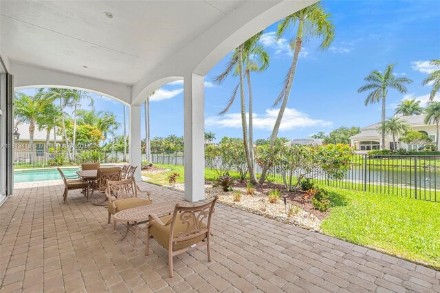 3250 W Stonebrook Cir, Davie, FL 33330 - view of patio / terrace featuring a water view and outdoor dining area