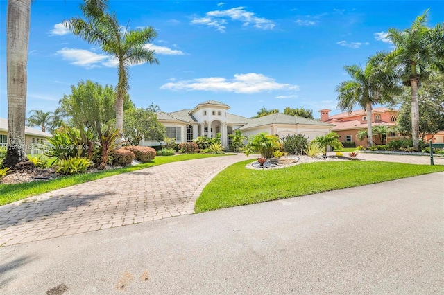 3250 W Stonebrook Cir, Davie, FL 33330 - mediterranean / spanish house featuring decorative driveway, a front yard, and stucco siding