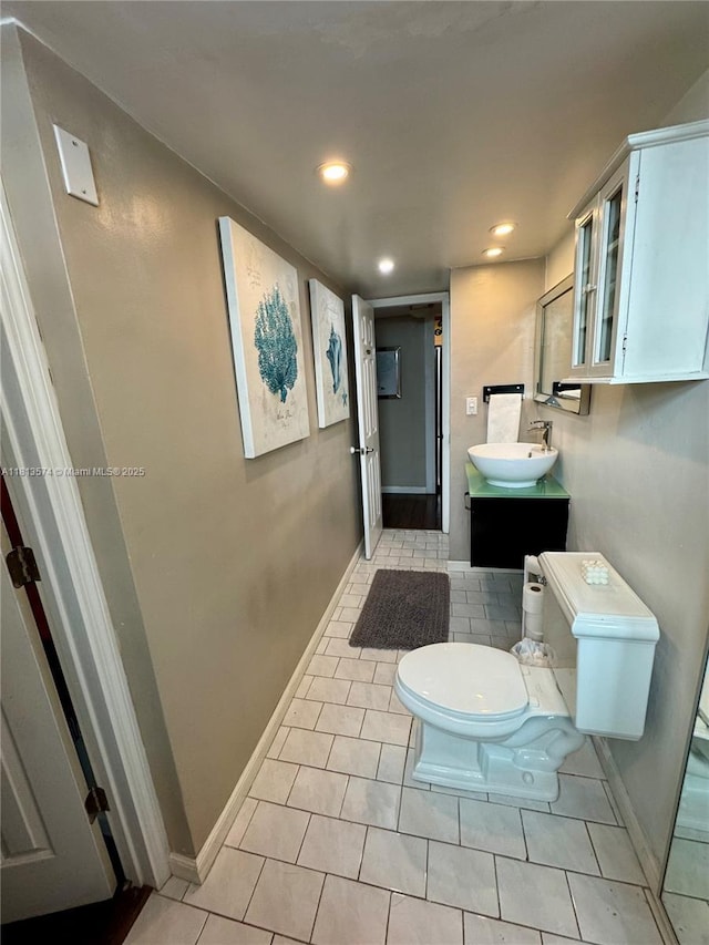 6900 Bay Dr Unit 10D, Miami Beach, FL 33141 - bathroom with toilet, vanity, tile patterned flooring, recessed lighting, and baseboards