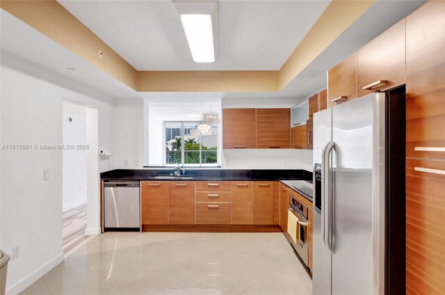 3330 NE 190th St Unit 416, Aventura, FL 33180 - kitchen with stainless steel appliances, dark countertops, light tile patterned flooring, and modern cabinets