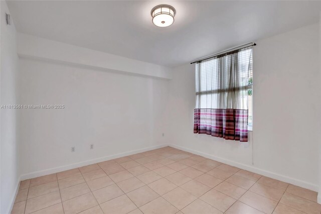 3330 NE 190th St Unit 416, Aventura, FL 33180 - spare room featuring light tile patterned flooring and baseboards