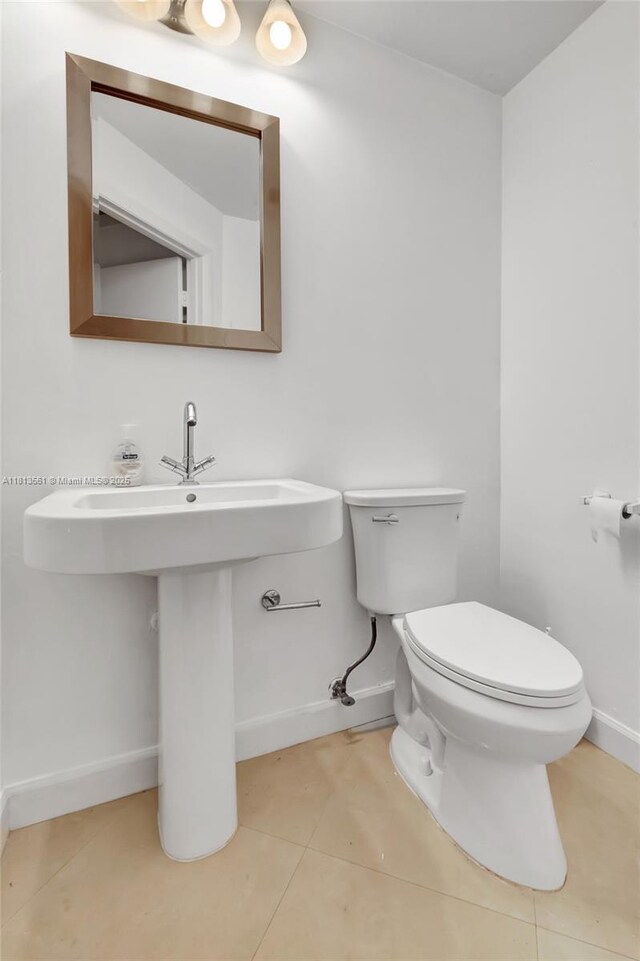 3330 NE 190th St Unit 416, Aventura, FL 33180 - half bathroom with tile patterned floors, toilet, baseboards, and a sink