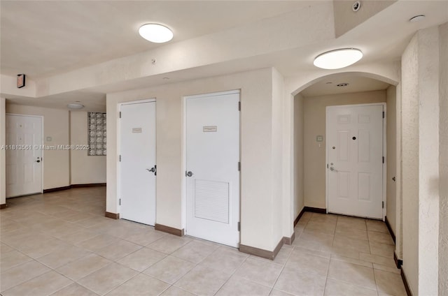 3330 NE 190th St Unit 416, Aventura, FL 33180 - spare room featuring arched walkways, light tile patterned floors, and baseboards