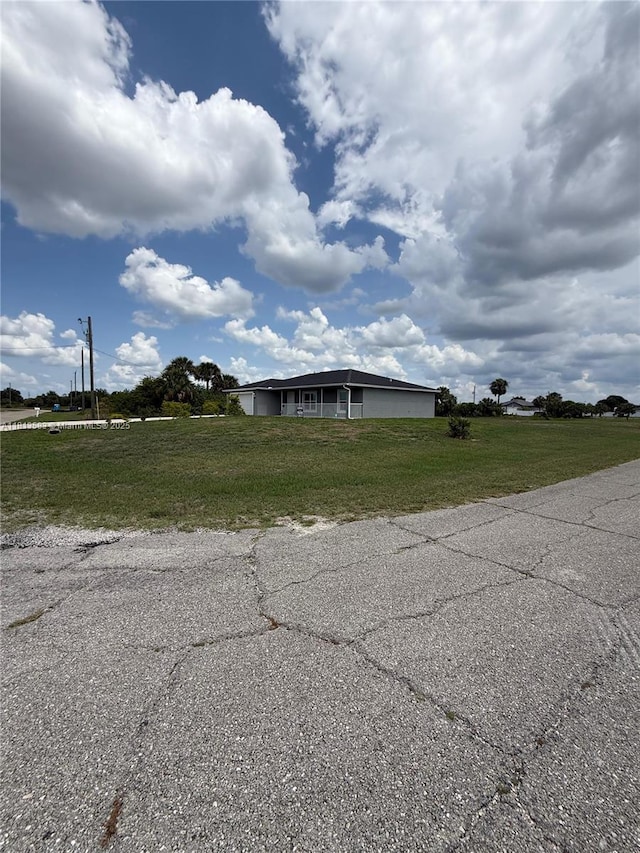 3031 Cherry Ln, La Belle, FL 33935 - view of side of property with a lawn
