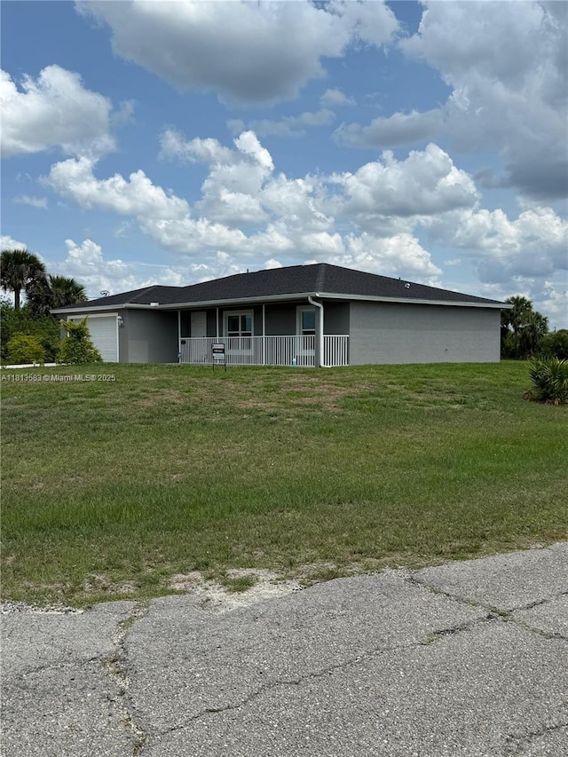 3031 Cherry Ln, La Belle, FL 33935 - view of front of home with an attached garage, a front lawn, and a porch