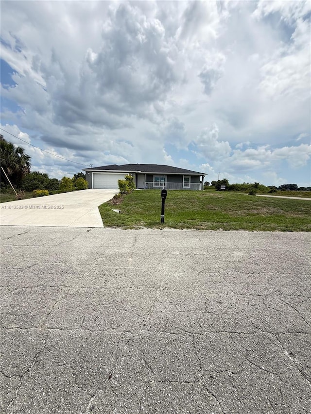 3031 Cherry Ln, La Belle, FL 33935 - ranch-style home with driveway, an attached garage, and a front lawn
