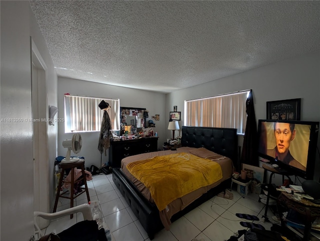 19080 NE 3rd Ct Unit 311, Miami, FL 33179 - bedroom with a textured ceiling and light tile patterned floors