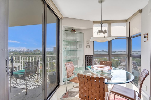 1000 Quayside Ter Unit 1101, Miami, FL 33138 - tiled dining area featuring a chandelier, plenty of natural light, a city view, and expansive windows