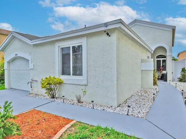 2810 River Run Cir E, Miramar, FL 33025 - view of side of property with a garage and stucco siding