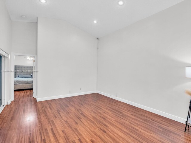 2810 River Run Cir E, Miramar, FL 33025 - spare room featuring wood finished floors, baseboards, vaulted ceiling, and recessed lighting