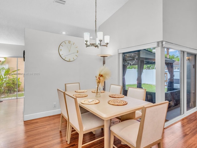 2810 River Run Cir E, Miramar, FL 33025 - dining space with wood finished floors, a chandelier, baseboards, and high vaulted ceiling
